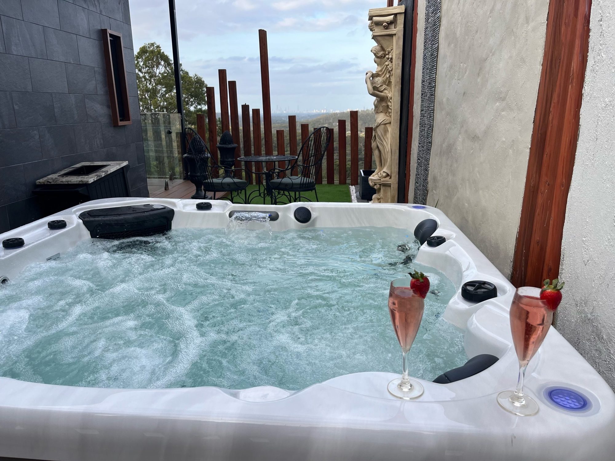 Private hydrotherapy spa in the villa courtyard with two glasses of bubbly