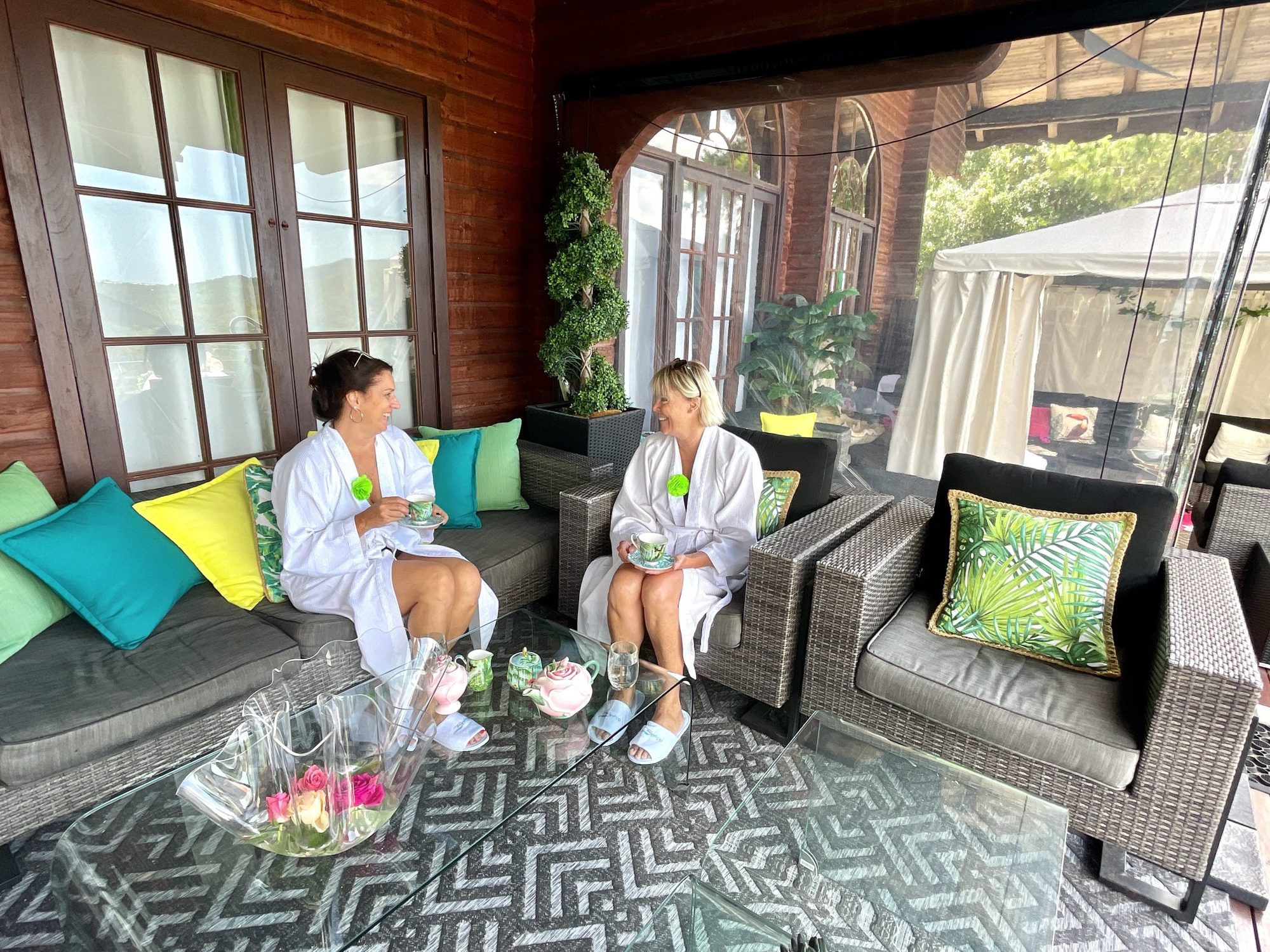 Guests in robes chatting in the garden room