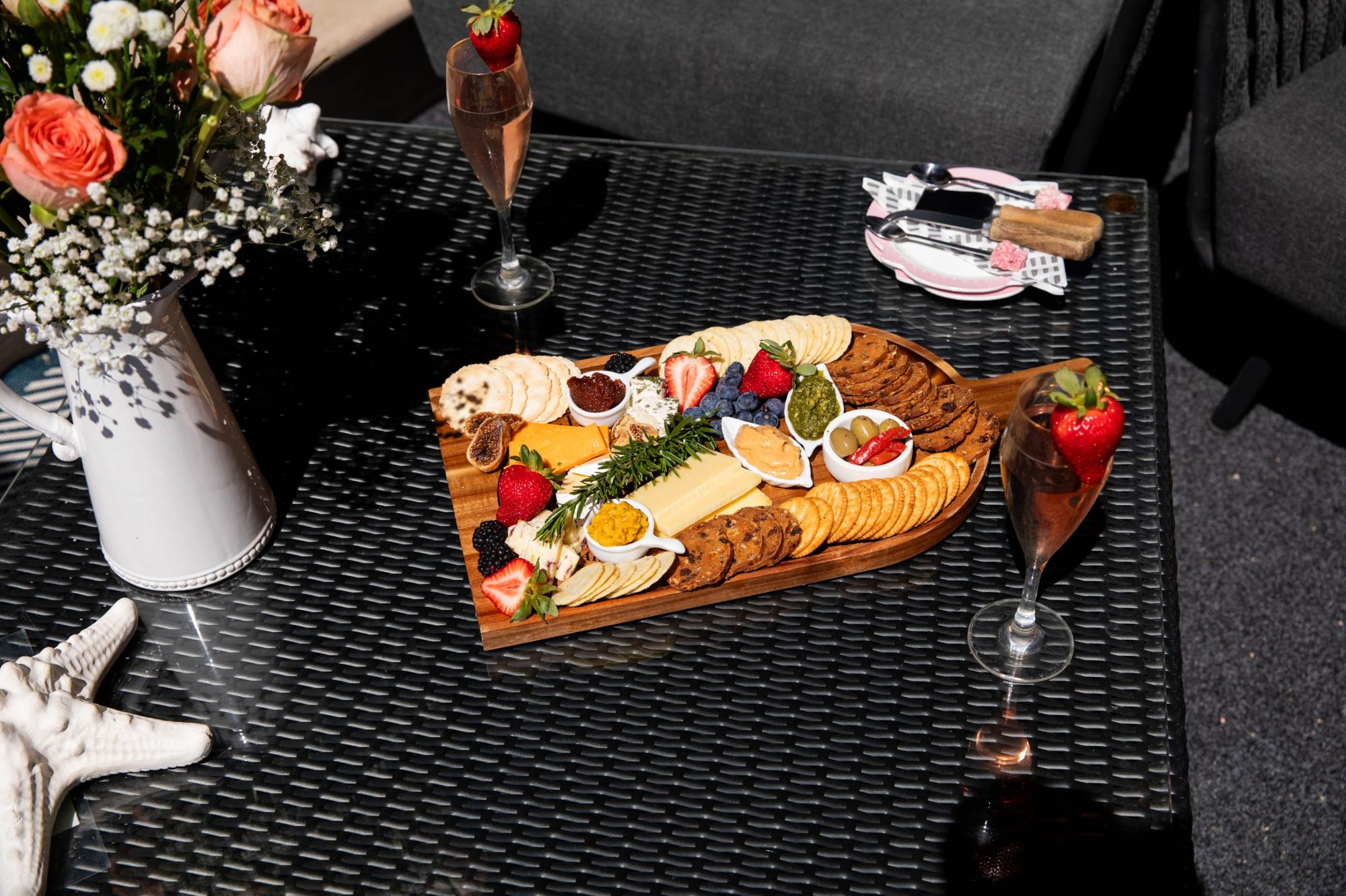Artisan cheese board with flowers and bubbly